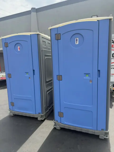 Two blue standard porta potties