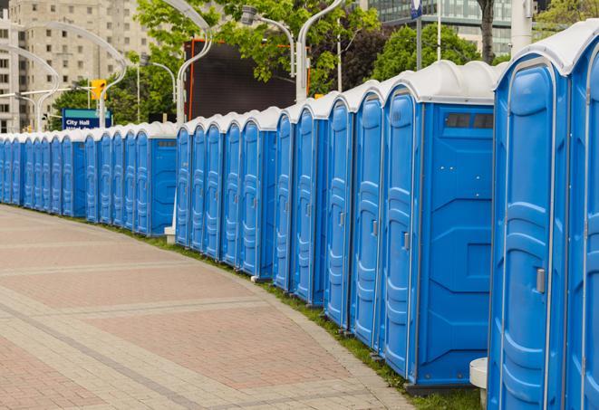 a row of portable restrooms at a fairground, offering visitors a clean and hassle-free experience in highlandpark